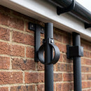 Adjustable Aluminium Pipe Clip 63mm Diameter — Textured Black (in use)