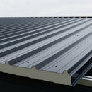 Anthracite 80mm PIR insulated composite roof panels installed on a shallow pitch workshop roof