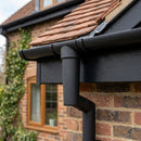 63mm Diameter Gutter Outlet Spigot Extender — Textured Black (in use)