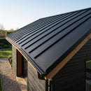 Garden room roof clad in matte black standing seam metal roofing panels