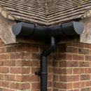 Textured black half round aluminium gutter installed on a traditional brick house fascia