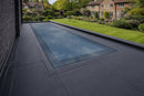 Frameless triple glazed flat roof skylight installed flush on a commercial flat roof with EPDM membrane