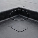 EPDM corner patch bonded over an internal upstand corner on a rubber flat roof with a spare patch alongside