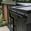 Textured black aluminium box gutter installed along a garden room fascia with round downpipe