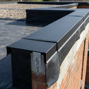 Textured black aluminium parapet coping installed on a flat roof EPDM membrane wall