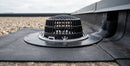 Aluminium flat roof refurbishment drain outlet installed on a commercial flat roof, draining into a 75mm downpipe