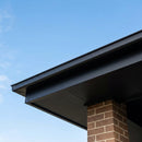 Black powder-coated aluminium fascia and soffit fitted along a house roofline eave