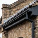 Black aluminium ogee gutter fitted below a Victorian brick roofline