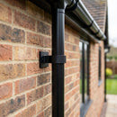 Aluminium Downpipe Clip 63mm Dia with 25mm Wall Offset — RAL 9005 (in use)