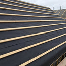 Black breathable roofing membrane installed over rafters on a pitched roof with timber battens fixed over it