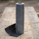 Roll of matt black breathable roofing membrane standing upright showing the woven fabric texture