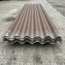 Stack of brown fibre cement roof sheets showing the deep Big 6 corrugation and grey core at the cut edge