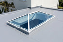 White aluminium roof lantern on a light grey EPDM flat roof orangery