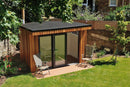 Completed timber-clad garden room with a black EPDM rubber flat roof