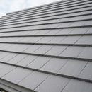 UK pitched roof covered in smooth grey interlocking concrete roof tiles
