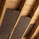 Natural cork insulation boards fitted between timber roof rafters during a UK pitched roof installation