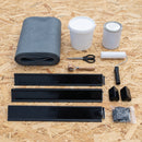 Dormer rubber roof kit contents laid out on an OSB deck: 1.2mm EPDM membrane, water-based deck adhesive, contact adhesive, gutter and kerb trims, corners, tool kit, clips and pins