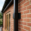Aluminium Downpipe Clip 72×72mm with 5mm Wall Spacing — RAL 9005 (in use)