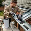 Installer bonding black EPDM rubber gutter lining into a box gutter beside a tiled roof – Finlock and concrete gutter relining