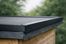 Black EPDM kerb edge trim fitted along the raised perimeter of a garden room rubber flat roof