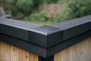 Black EPDM kerb trim external corner joining two kerb edge trims on a garden room rubber flat roof
