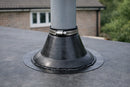 EPDM pipe flashing boot sealed around a soil pipe penetrating a dark grey rubber flat roof