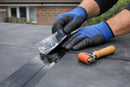 Roofer applying 75mm seam tape along an EPDM membrane overlap joint with release film and seam roller