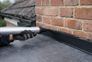 Bond and seal wall mastic being gunned along the top edge of a wall flashing trim on an EPDM rubber roof