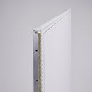 Close-up of the fire-rated loft hatch door edge showing the insulated core and steel frame detail