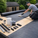 Roofer laying EPDM membrane with complete garage rubber roof kit components including trims and adhesive - UK