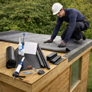 Roofer fitting EPDM membrane on garden room with plastic edge trim kit - complete rubber roof kit with fixings UK