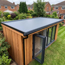 Cedar-clad garden office with a finished 1.2mm slate grey EPDM rubber roof, black kerb trims on three sides and gutter drip trim on the long edge