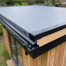 Close-up of the garden room roof corner where the black gutter drip trim meets the kerb trim with a moulded external corner over slate grey EPDM