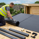 Safety-vest roofer rolling EPDM membrane on garden room with plastic edge trim components laid out - EPDM kit UK
