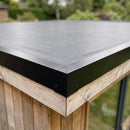Close-up of the 40 x 75 mm black metal edge trim and corner piece fitted over EPDM membrane on a garden room roof