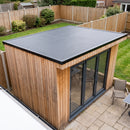 Finished cedar-clad garden office with a one-piece black EPDM rubber roof and black metal edge trims on all four sides - garden room rubber roof kit