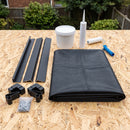 Garden roof kit contents laid out on an OSB deck: EPDM membrane, water-based deck adhesive, roller, edge mastic, black uPVC kerb and drip trims, corners, clips and pins
