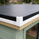 Close-up of white uPVC kerb edge trim and corner piece fitted over black EPDM membrane on a garden room roof