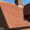 Handmade clay plain roof tiles in Red Antique installed on a traditional UK pitched roof