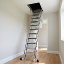 Heavy-duty aluminium concertina loft ladder fully extended from an insulated white ceiling hatch in a UK hallway