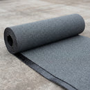Roll of charcoal mineral bitumen roofing felt partly unrolled showing granule surface and bitumen underside