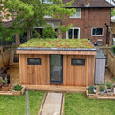 Modular pre-grown sedum green roof trays installed on a garden room flat roof