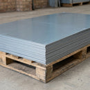 Stack of flat natural zinc roofing sheets on a timber pallet showing sheet edges