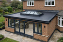 UK brick orangery extension with dark grey EPDM rubber flat roof surrounding a central glass roof lantern, finished with black edge trims