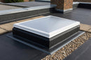 Flat roof access hatch dome installed and bonded into a black EPDM flat roof, closed