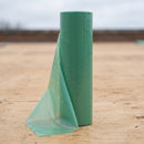 Roll of translucent green polythene vapour control layer standing on a solid roof deck