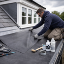 Roofer laying EPDM membrane on dormer flat roof with ClassicBond adhesive - professional dormer EPDM roof kit UK