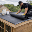 Roofer laying EPDM rubber membrane on garden shed flat roof - complete shed rubber roof kit UK