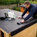 Roofer rolling EPDM membrane on premium garden shed flat roof with adhesive kit - shed rubber roof kit UK