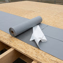Self-adhesive roofing underlay membrane being bonded to a timber roof deck with release liner peeling back